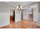 Elegant dining room with hardwood floors and detailed trim leading to kitchen and stairs at 3085 Woodbridge Ln, Canton, GA 30114
