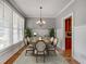 Formal dining room with beautiful chandelier, natural light and decorative wainscoting at 3085 Woodbridge Ln, Canton, GA 30114