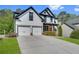 Inviting two-story home with a two-car garage and lush green lawn at 3085 Woodbridge Ln, Canton, GA 30114