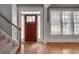 Foyer featuring hardwood floors, staircase, and natural light from the nearby window at 3085 Woodbridge Ln, Canton, GA 30114