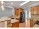 Modern kitchen featuring granite countertops, wood cabinets, stainless steel appliances, and a breakfast bar at 3085 Woodbridge Ln, Canton, GA 30114