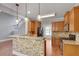 Modern kitchen with granite countertops, wood cabinetry, stainless steel appliances and stone-clad breakfast bar at 3085 Woodbridge Ln, Canton, GA 30114