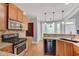 Well-equipped kitchen with stainless steel appliances, granite countertops, wood cabinets, and hardwood floors at 3085 Woodbridge Ln, Canton, GA 30114