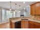 Bright kitchen features granite countertops, stainless steel appliances, breakfast nook with window seat and custom pendant lights at 3085 Woodbridge Ln, Canton, GA 30114