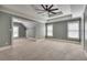 Large main bedroom featuring plush carpeting and a tray ceiling with a fan at 3085 Woodbridge Ln, Canton, GA 30114