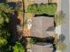 Aerial view of home showing a fire pit, patio dining, a well-kept lawn, and mature trees at 1749 Grand Oaks Dr, Woodstock, GA 30188