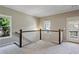 Carpeted second story landing featuring a staircase, windows, and access to the balcony at 1749 Grand Oaks Dr, Woodstock, GA 30188
