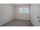 Cozy bedroom filled with natural light from the window and new carpeting at 2038 Thomasville Se Dr, Atlanta, GA 30315
