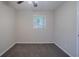 Bedroom features neutral carpeting, a ceiling fan, and natural light from the window at 2038 Thomasville Se Dr, Atlanta, GA 30315