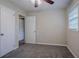 Carpeted bedroom with ceiling fan and ample natural light from a large window at 2038 Thomasville Se Dr, Atlanta, GA 30315
