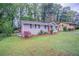 Cozy home featuring a landscaped front yard with mature trees and blossoming shrubs at 2038 Thomasville Se Dr, Atlanta, GA 30315