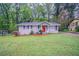 Charming single-story home with a well-maintained lawn and a vibrant red front door at 2038 Thomasville Se Dr, Atlanta, GA 30315