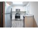 Updated kitchen with stainless steel appliances, granite countertops, and white cabinetry at 2038 Thomasville Se Dr, Atlanta, GA 30315