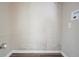 This laundry room features painted brick accents, modern flooring, and convenient utility hookups at 2038 Thomasville Se Dr, Atlanta, GA 30315