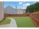 Expansive backyard featuring lush greenery, a stone walkway, and privacy fencing for outdoor enjoyment at 2480 Sheldon Pl, Cumming, GA 30040