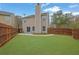 Spacious backyard with lush green grass, fenced perimeter, and a patio perfect for outdoor enjoyment at 2480 Sheldon Pl, Cumming, GA 30040