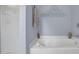 Bathroom featuring blue walls, glass shower doors, a soaking tub and a towel rack at 2480 Sheldon Pl, Cumming, GA 30040