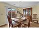 The dining room features hardwood floors, a chandelier, and a sliding door at 2480 Sheldon Pl, Cumming, GA 30040