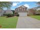Charming two-story home with a well-maintained lawn, two-car garage, and inviting curb appeal at 2480 Sheldon Pl, Cumming, GA 30040