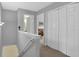 Hallway with gray walls, neutral carpet, white trim and three large closets at 2480 Sheldon Pl, Cumming, GA 30040