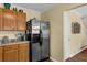 Kitchen with wooden cabinets, stainless steel refrigerator and tile countertops at 2480 Sheldon Pl, Cumming, GA 30040