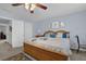 Main bedroom with blue walls, natural wood furniture, carpet, and a ceiling fan at 2480 Sheldon Pl, Cumming, GA 30040
