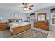 Bedroom with blue walls, natural wood furniture and a ceiling fan at 2480 Sheldon Pl, Cumming, GA 30040