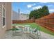 Inviting patio area with a small table and chairs, perfect for relaxing in the landscaped backyard at 2480 Sheldon Pl, Cumming, GA 30040