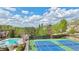 Community amenities view featuring a large swimming pool and well-maintained tennis courts at 3546 Flycatcher Way, Duluth, GA 30097