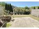 Private backyard with a concrete patio, bordered by mature landscaping and fencing at 3546 Flycatcher Way, Duluth, GA 30097