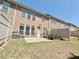Exterior view of townhome back yard, showing a concrete patio, landscaping and fenced yard at 3546 Flycatcher Way, Duluth, GA 30097