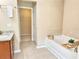 Bright bathroom with tub, shower, vanity, and access to a closet at 3546 Flycatcher Way, Duluth, GA 30097
