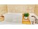 Close up of bright soaking tub with tile backsplash and faucet at 3546 Flycatcher Way, Duluth, GA 30097