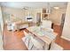 Open-concept dining and living area with hardwood floors, offering seamless flow and modern design at 3546 Flycatcher Way, Duluth, GA 30097