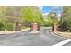 Gated community entrance with brick pillars, providing security and enhancing curb appeal at 3546 Flycatcher Way, Duluth, GA 30097
