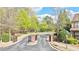 Community entrance with brick pillars, a gated entry, and lush landscaping creating a welcoming atmosphere at 3546 Flycatcher Way, Duluth, GA 30097