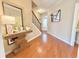 Inviting hallway with hardwood floors, elegant decor, and staircase at 3546 Flycatcher Way, Duluth, GA 30097