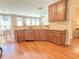 Well-appointed kitchen featuring warm wood cabinetry, stainless steel appliances, and hardwood floors at 3546 Flycatcher Way, Duluth, GA 30097