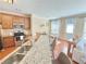 Well-lit kitchen with stainless steel appliances and breakfast bar, connecting to dining and living areas at 3546 Flycatcher Way, Duluth, GA 30097