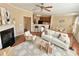 Cozy living area with a fireplace, open to the kitchen and dining, features stylish decor and ample seating at 3546 Flycatcher Way, Duluth, GA 30097