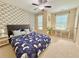 Stylish main bedroom featuring statement wallpaper, study space, and ceiling fan at 3546 Flycatcher Way, Duluth, GA 30097
