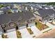 A front aerial view showcases modern townhomes with manicured lawns and ample parking at 847 Pensive Run, Dacula, GA 30019