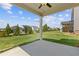 A covered back patio overlooking a spacious, well maintained lawn at 847 Pensive Run, Dacula, GA 30019