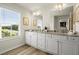 This bathroom offers a dual vanity with granite counters and a large window for natural light at 847 Pensive Run, Dacula, GA 30019