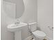Contemporary bathroom featuring a pedestal sink and oval mirror at 847 Pensive Run, Dacula, GA 30019