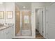 This bathroom features a tiled walk-in shower with a glass door and a granite countertop at 847 Pensive Run, Dacula, GA 30019