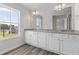 Bathroom vanity featuring double sinks, granite countertops, and ample storage with great natural light at 847 Pensive Run, Dacula, GA 30019
