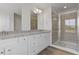 Bright bathroom featuring a double vanity with granite counters and a glass-enclosed shower at 847 Pensive Run, Dacula, GA 30019