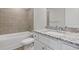 A bathroom featuring a vanity with granite counters, a toilet, and a tub with shower at 847 Pensive Run, Dacula, GA 30019