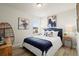 This bedroom includes a comfortable bed, large window, and stylish wall art at 847 Pensive Run, Dacula, GA 30019